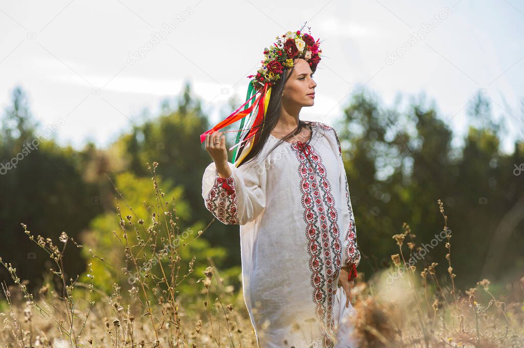 Outdoor portrait of beautiful pregnant Ukrainian woman.