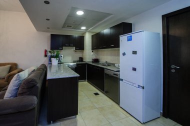 Cozy studio apartment design with bedroom and living space. Hotel room panoramic window, double bed, sofa and coffee table. Urban apartment concept