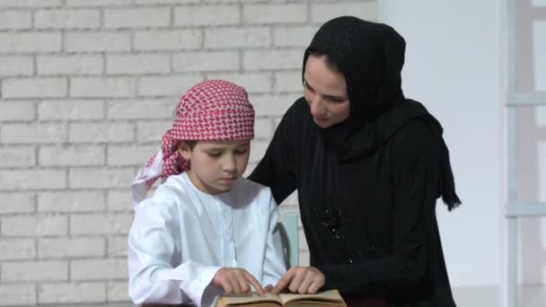 Happy Arabic Mother Son Together Sitting Couch Reading Book — Stock Video