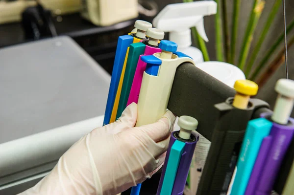 Hands with test tubes close-up. Hands in medical gloves hold tubes. Concept blood test for the presence of a virus. Viral disease test. Human blood in the laboratory. Virusology.