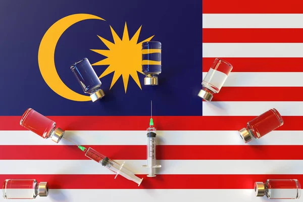 Glass vials and syringes on the flag of Malaysia. Vaccination related conceptual 3D rendering — Stock Photo, Image