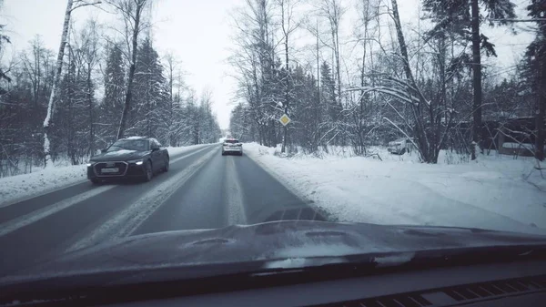 MOSCOW REGION, RUSSIA - DECEMBER 26, 2021. Driving a car along rural road in the snow, POV shot — Zdjęcie stockowe