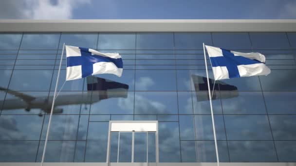 Bandeiras da Finlândia no aeroporto e desembarque de avião comercial — Vídeo de Stock