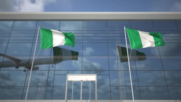 Flaggor i Nigeria på flygplatsen och landning kommersiella flygplan — Stockvideo