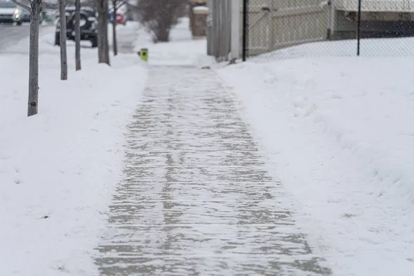 city pavement sidewalk cleared of snow in winter