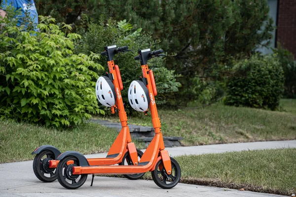 August 22 2022 - Calgary Alberta Canada - Electric Scooters with helmets on a street — Stock Photo, Image