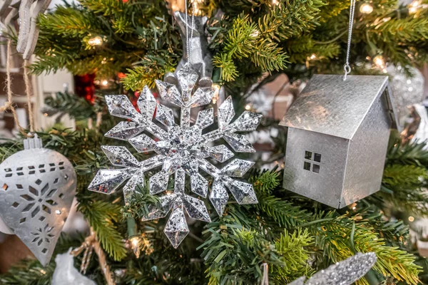 Decorations and baubles haniging from a christmas tree — Stock Photo, Image