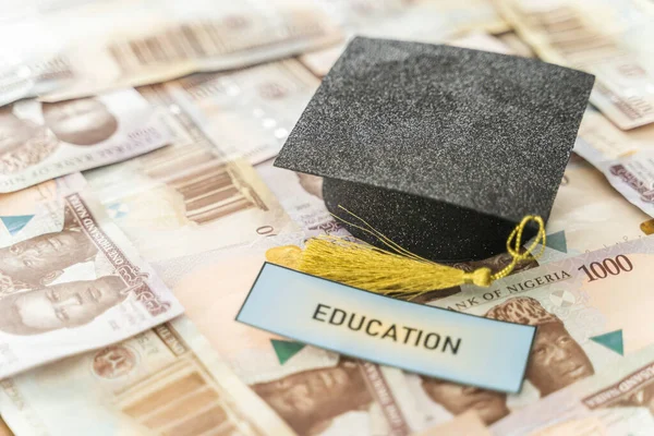 University Mortarboard academic cap on Nigerian Naira notes - Savings for education