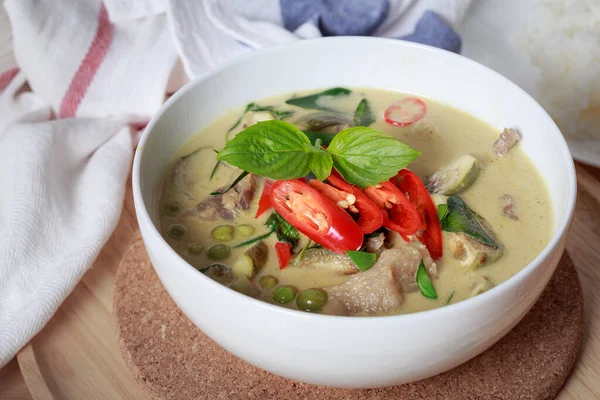 Green curry, Thai green curry with beef chilli and eggplant garnished with sliced fresh chilli and basil leaf