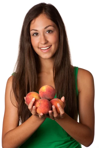 Pretty smiling woman with red peaches — Stok fotoğraf