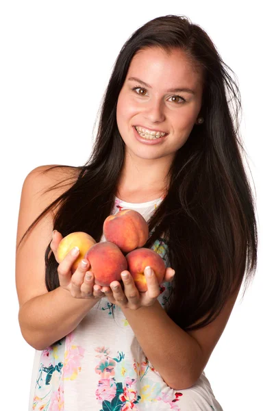Pretty smiling woman with red peaches — Stock Photo, Image
