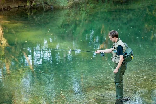 A fisherman fishing on a river — Stock Photo, Image