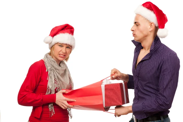 Girl and man with santa hat fighting for a present — Stock Photo, Image