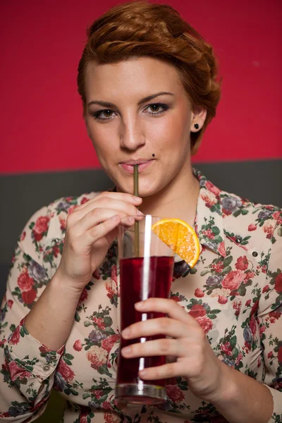 Attractive young woman drinks icetea in a bar — Stock Photo, Image