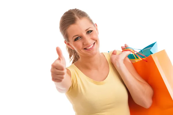 Attractive young woman with vibrant shopping bags isolated over — Stock Photo, Image