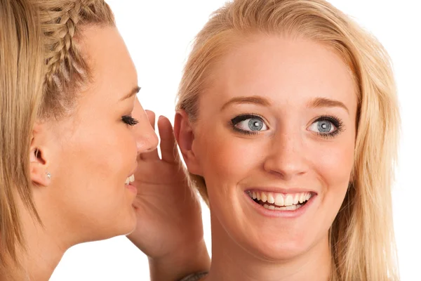 Girls chat - woman whispers on friends ear — Stock Photo, Image