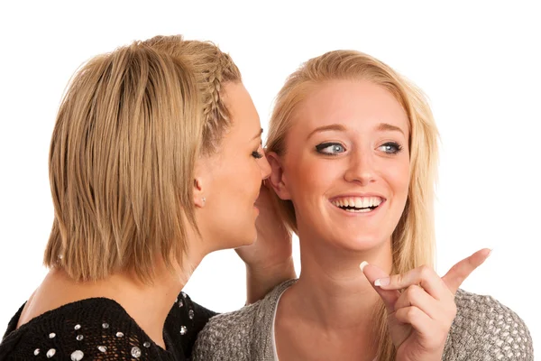 Girls chat - woman whispers on friends ear — Stock Photo, Image