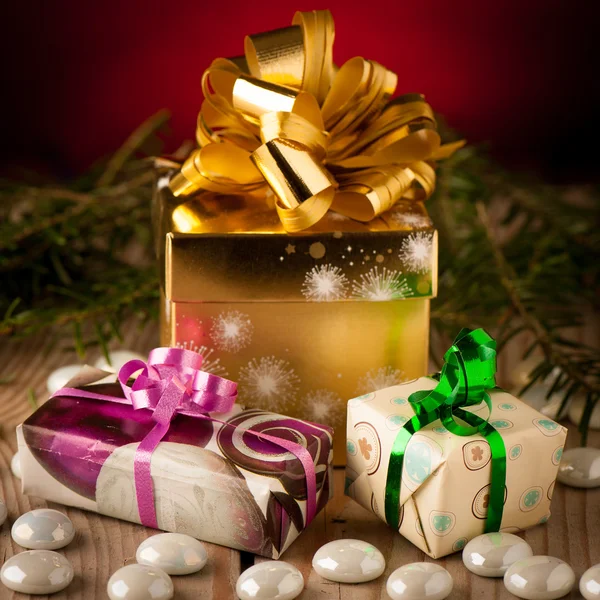 Christmas gifts arranged on a table with spruce branches and lig Stock Photo