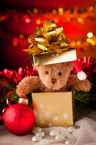 Plush bear in golden present box christmas ornaments with lights Stock Picture