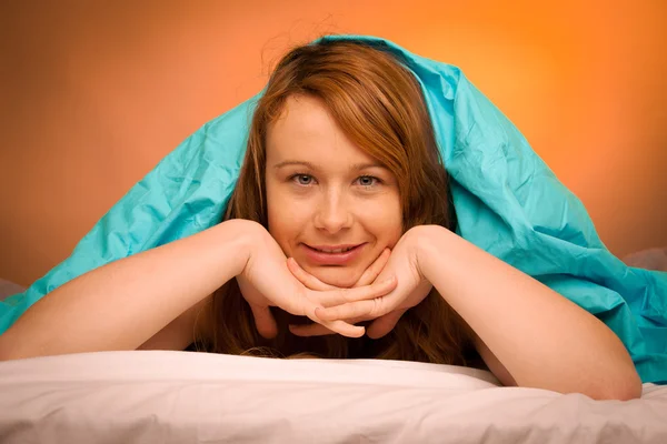 Mujer hirviendo sobre almohada en la cama, cubierta con manta —  Fotos de Stock