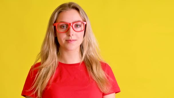 Beautiful Young Woman Red Shirt Smiles Vibrant Yellow Background — Stock Video
