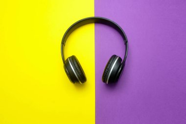 Wireless headphones  on a yellow - purple background 