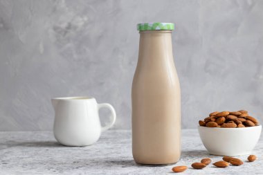 Masada badem sütü var. Vejetaryen bitkisel ürün. Sağlıklı gıda konsepti, laktozsuz yemek. Seçici odak