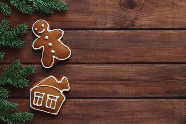Fotokopi alanı olan bir Noel arkaplanı. Zencefilli adam ve ağaç dallı ev kurabiyeleri. Üst manzara, düz uzanma.