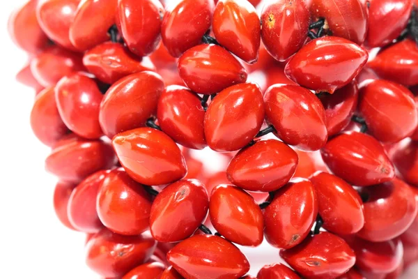Strand with red beads over white background — Stock Photo, Image