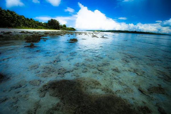 Transparent sea water and blue sky with clouds — Stock Photo, Image