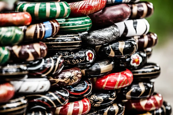 Rows of colorful wooden hand-painted bracelets — Stock Photo, Image