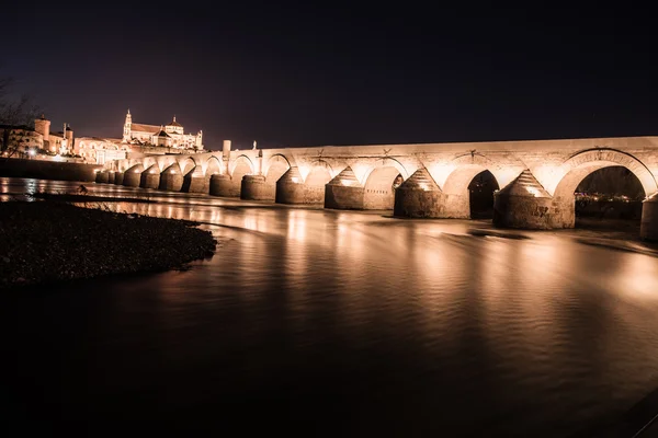 Ponte Romana sobre o rio Guadalquivir e a Grande Mesquita (Catedral de Mezquita) no crepúsculo da cidade de Córdoba, Andaluzia, Espanha . — Fotografia de Stock