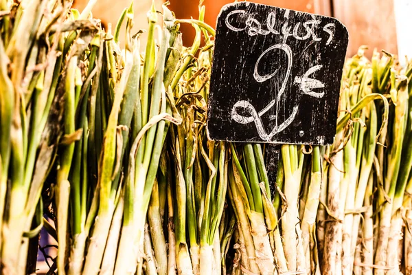 Une rangée soignée d'oignons de printemps conditionnés pour la vente au marché . — Photo