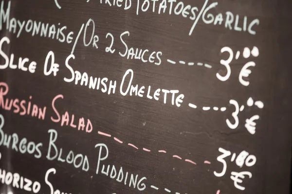 Foreground of a poster of the menu in a typical Spanish restaurant, Sevilla, Andalusia, Spain — Stock Photo, Image