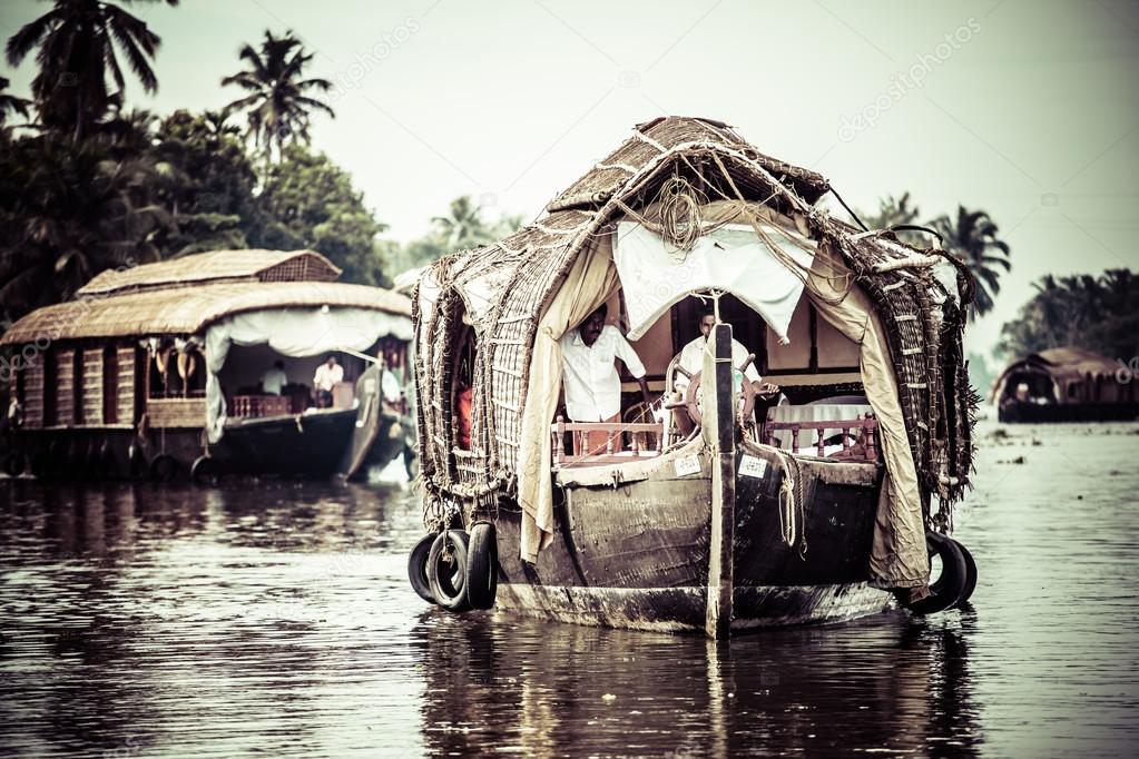House boat in backwaters near palms in Alappuzha, Kerala, India