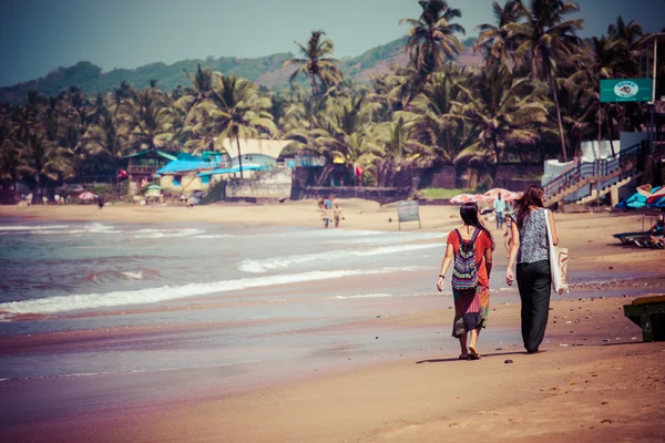 Exiting Anjuna beach panorama on low tide with white wet sand and green coconut palms, Goa, India — Stock Photo, Image