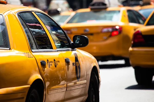 Yellow cab speeds through Times Square in New York, NY, USA.