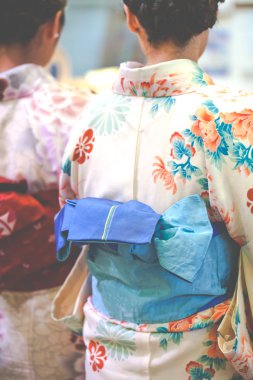Japanese women wear a traditional dress called Kimono for Sakura viewing at Kiyomizu temple in Kyoto  clipart