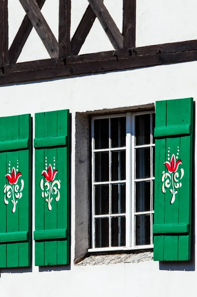 Typical germany windows with green shutters and window box — Stock Photo, Image