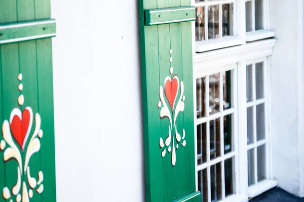 Typical germany windows with green shutters and window box — Stock Photo, Image