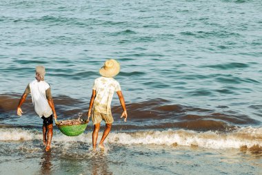 Negombo, Sri Lanka sahillerinde balıklarla çalışan insanlar.