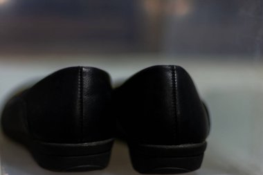 Black leather women shoes on natural light background.