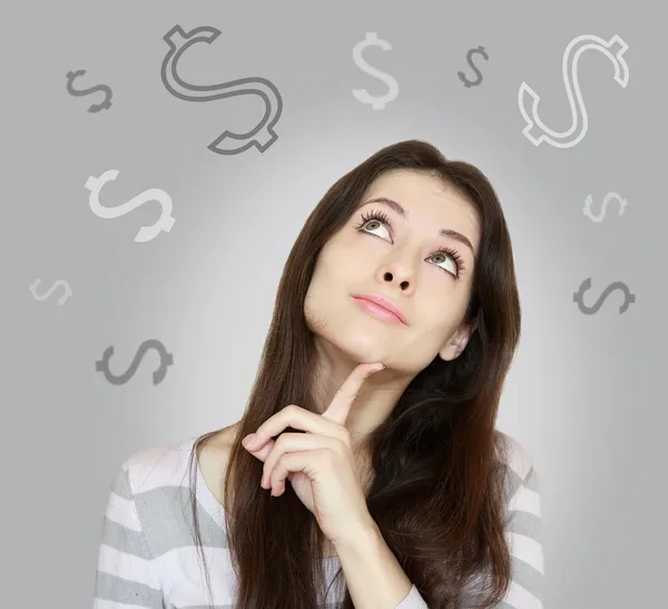 Young woman thinking about money and looking up on grey backgrou — Stock Photo, Image