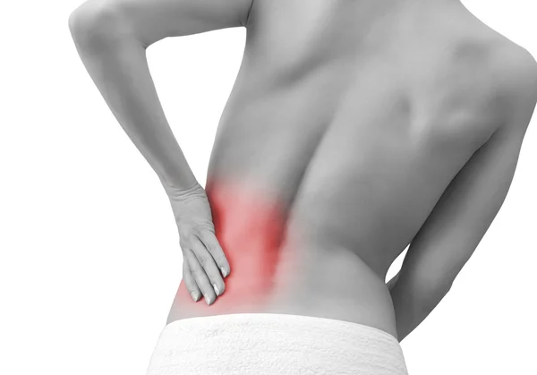 Mulher de mão dada suas costas no esporte dor isolada no branco — Fotografia de Stock