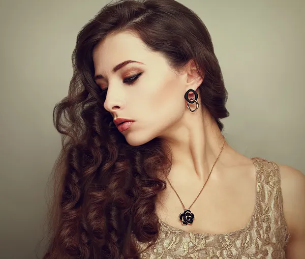 Beautiful profile of female model looking down with long brown curly hair. Vintage portrait — Stock Photo, Image