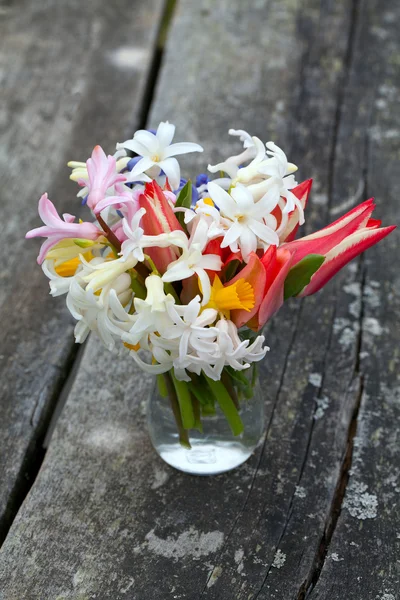 Spring flowers on wooden table — Stock Photo, Image