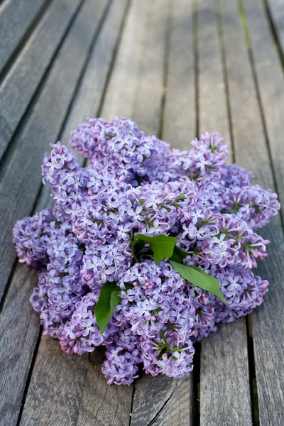 Lilac on wooden surface — Stock Photo, Image