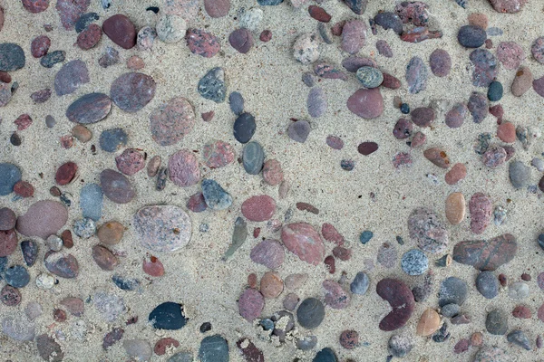Kövek a tengerparton homok — Stock Fotó