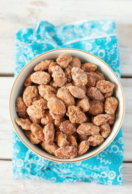 Beyaz ahşap yüzeyde karamelize edilmiş badem.