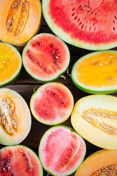 Variety of melons and water melons on wooden surface. Food backgrounds. Top view.